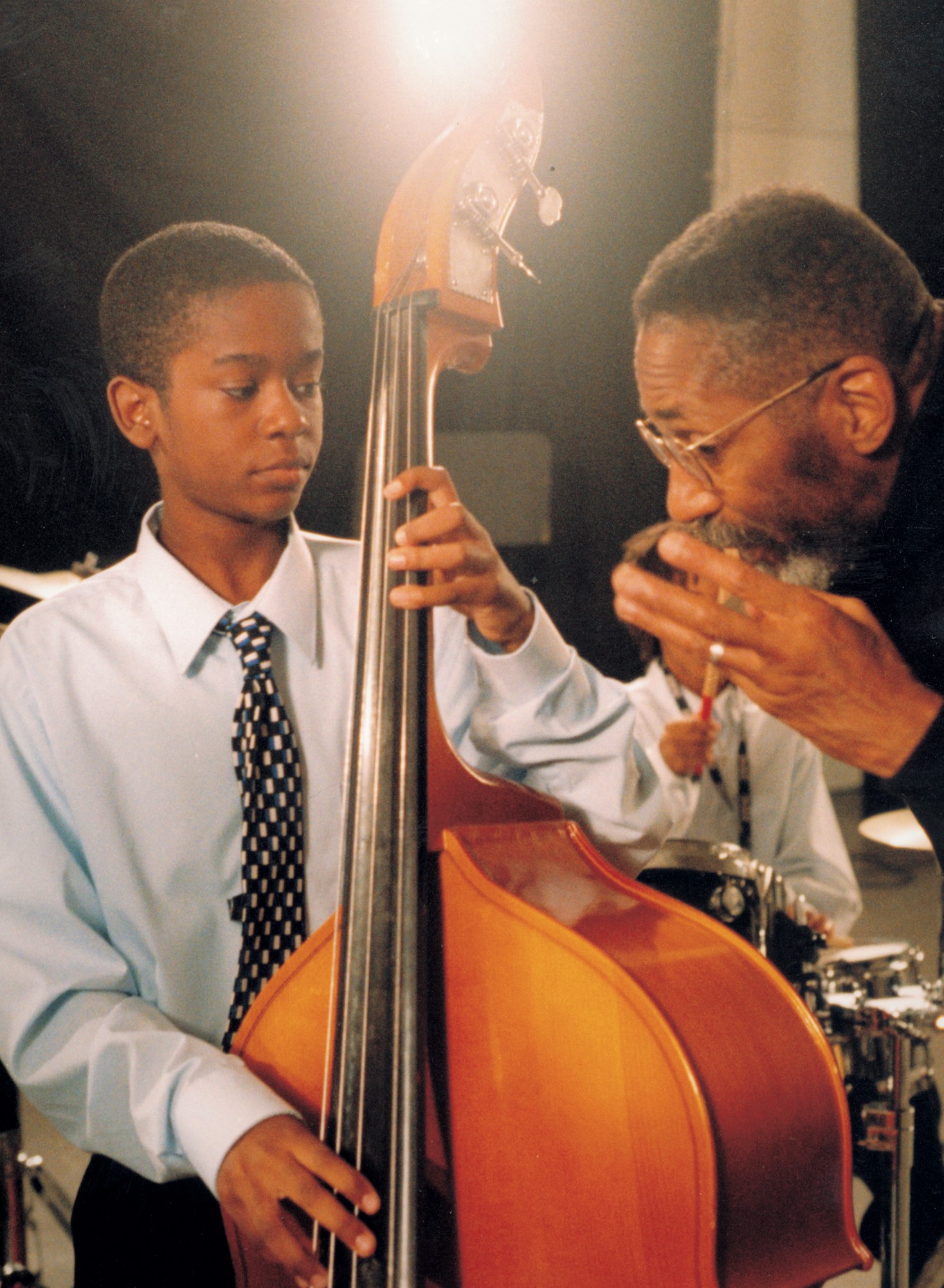 Bassist Ron Carter explains a concept to a young Ben Williams