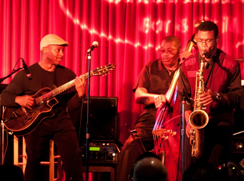 Guitarist and teaching artist Kevin Eubanks performs with student  saxophonists (from left) Javon Harvey and Nico Galvan as part of a Jazz in  the Classroom event at Catalina's jazz club in Los